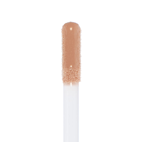 Doe-foot applicator coated in Major Throwback Ultra Glossy Lip, a warm nude-beige gloss with fine shimmer reflecting light for a high-shine finish, shown in a clean macro on white; ColourPop Ultra Glossy Lip.