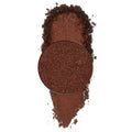 Material Girl ColourPop Pressed Powder Shadow pan spills crushed metallic deep copper-brown shimmer into a soft swatch, with the round refill centered on a clean white background.