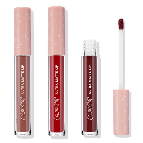ColourPop Ultra Matte Lip Matte Babe set showing three liquid lipstick tubes - taupe brown, classic red, and deep burgundy - with one opened to reveal a doe-foot applicator; pink starry caps on a white background.