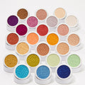 Obvi ColourPop Super Shock Shadow displays its shimmery, scale-textured pan, shown open amid a rainbow of Super Shock Shadow singles in white round pots, arranged tightly on a clean white background.