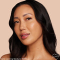 ColourPop Pretty Fresh Creamy Concealer in Medium 100 W evening skin tone on a model’s face, showing a warm undertone and natural dewy coverage in a close-up portrait against a soft beige background.