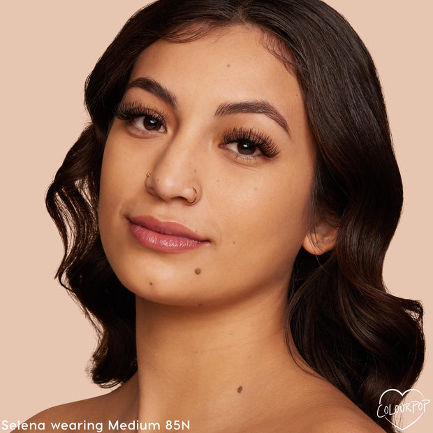 ColourPop Pretty Fresh Creamy Concealer in Medium 85 N showcasing a neutral-toned shade on a model, delivering smooth, natural coverage with a soft, hydrated finish; close-up face against a warm beige background for shade reference.