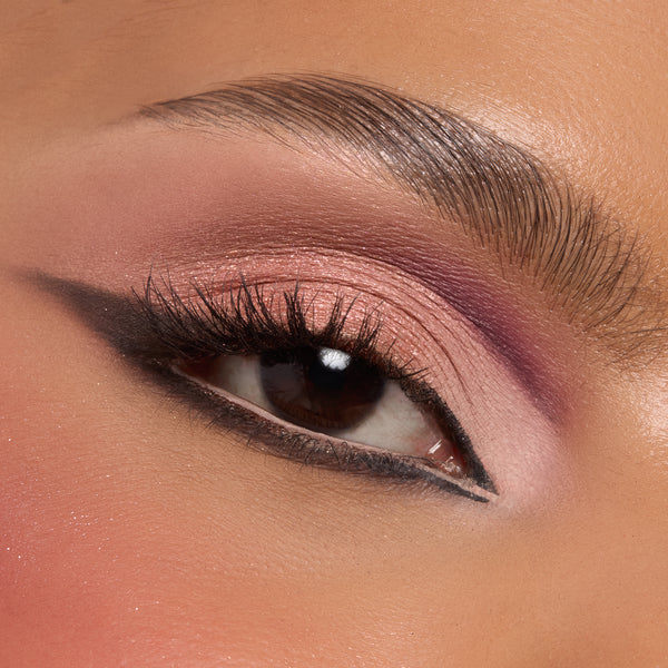 Rosy pink shimmer and mauve shadow from the Smoke 'N Roses ColourPop Shadow Palette sweep across an eyelid, blended into a soft smoky wing with black liner and full lashes, close-up to showcase pigment payoff and satin finish.