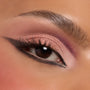 Rosy pink shimmer and mauve shadow from the Smoke 'N Roses ColourPop Shadow Palette sweep across an eyelid, blended into a soft smoky wing with black liner and full lashes, close-up to showcase pigment payoff and satin finish.