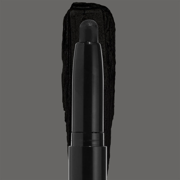 ColourPop Shadow Stix in Midnight Hour depositing a rich jet-black eyeshadow swatch, the rounded stick tip centered over a bold black smear on a gray backdrop, sleek black barrel emphasizing the smoky shade.
