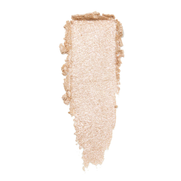 Mighty Morphin' ColourPop Super Shock Shadow swatch smeared in a vertical swipe, showing a metallic champagne-beige shimmer with fine sparkle and creamy texture against a clean white background.