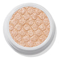 Mighty Morphin’ ColourPop Super Shock Shadow shimmers in a metallic champagne-gold, pressed with a quilted texture in an open white pot, close-up on a white background.