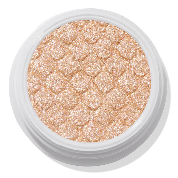 Mighty Morphin’ ColourPop Super Shock Shadow shimmers in a metallic champagne-gold, pressed with a quilted texture in an open white pot, close-up on a white background.