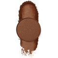 Single round copper-brown eyeshadow with gold flecks resting on a swatched trail of loose pigment on white, showcasing Mission, a ColourPop Pressed Powder Shadow.