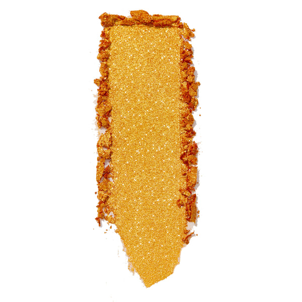 Gold metallic eyeshadow swatch glides in a thick vertical stripe with sparkly flecks and crumbly edges on white, showcasing Montecito Super Shock Shadow by ColourPop, a warm marigold shade with high-shine glitter payoff.