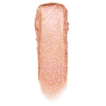 Shimmering rose‑gold peach swipe with fine pink sparkle shows Mystical Jelly Much Shadow texture on a white background, highlighting its glossy-to-metallic payoff; ColourPop Jelly Much Shadow single eyeshadow swatch.