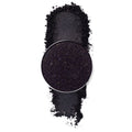 ColourPop Nightdream pressed powder shadow pan showcasing a deep black‑purple eyeshadow packed with fine multicolor sparkle, displayed with a crushed swatch on a white background, highlighting its glittery smoky finish.