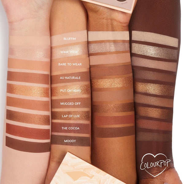 ColourPop Shadow Palette Nude Mood swatches across three arms (light, medium, deep), showing nine neutral mattes and metallics - Bluffin’, Wink Wink, Au Naturale, Lap of Lux, and Moody - from pale beige to rich cocoa; palette corner visible.