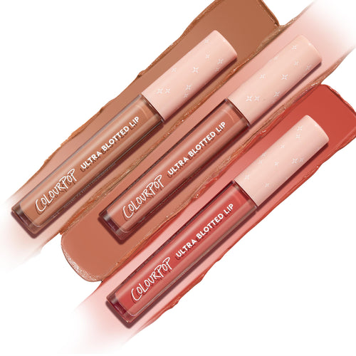 OG Babes Ultra Blotted Lip bundle featuring three ColourPop Ultra Blotted Lip tubes with star-print pink caps, arranged diagonally over swatches in warm nude, peachy nude, and rosy terracotta on a white background.