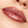 Glossy lips lined and softly filled with Oh Sis, a neutral rosy-brown ColourPop Lippie Pencil, creating smooth, defined edges in a tight close-up beauty shot of the mouth and nose area.