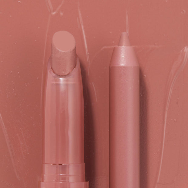 Double the Trouble ColourPop Lippie Stix + Pencil Set shown side by side in a warm rosy nude; the twist-up Lippie Stix and matching precision pencil rest on a glossy pink swatched backdrop, highlighting the coordinated shade for lining and filling lips.