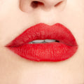 Bold red lips wear Overtime ColourPop Lippie Pencil, lining and filling with a smooth matte finish in a studio close-up, showing crisp definition and saturated color for a precise, long-wear look.