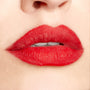 Bold red lips wear Overtime ColourPop Lippie Pencil, lining and filling with a smooth matte finish in a studio close-up, showing crisp definition and saturated color for a precise, long-wear look.