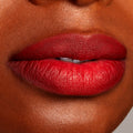 Full lips lined and filled with ColourPop Lippie Pencil in Overtime, showcasing a rich cherry-red matte finish with crisp edges; close-up beauty swatch on medium-deep skin for shade reference.