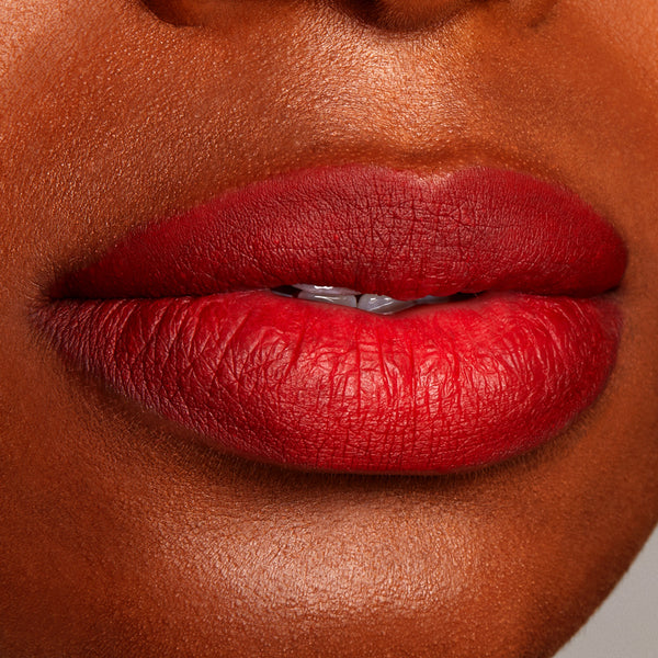 Full lips lined and filled with ColourPop Lippie Pencil in Overtime, showcasing a rich cherry-red matte finish with crisp edges; close-up beauty swatch on medium-deep skin for shade reference.