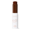ColourPop Pretty Fresh Tinted Foundation Balm in Deep Dark 24, open twist-up stick showing a deep chocolate-brown balm bullet, standing upright in a white tube with peach lettering on a clean white background.