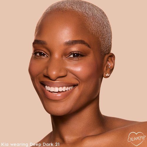 ColourPop Pretty Fresh Tinted Foundation Balm in Deep Dark 21 evening a model's deep skin tone with a natural, radiant finish; close-up studio portrait on a beige background showcasing smooth coverage and soft glow.