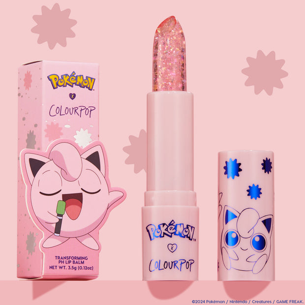 ColourPop pH Lip Balm Sing stands uncapped, revealing a clear glittery bullet beside its pink Pokémon x ColourPop box and matching cap with blue starbursts and Jigglypuff art, set against a pastel pink background.