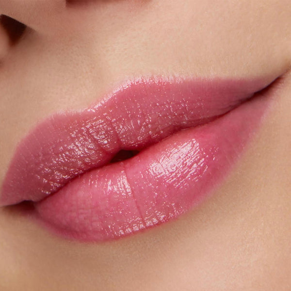 Glossy lips wearing Sing pH Lip Balm from the ColourPop pH Lip Balm line, transforming to a sheer rosy-pink tint in a tight beauty close-up, highlighting the hydrating, pH-reactive, smooth, shiny finish.