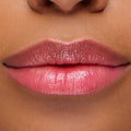 Glossy lips wearing Thunderbolt pH Lip Balm, a pH-activated balm that shifts to a custom rosy pink with high shine and hydration; close-up swatch showcases the sheer, buildable color of the ColourPop pH Lip Balm.