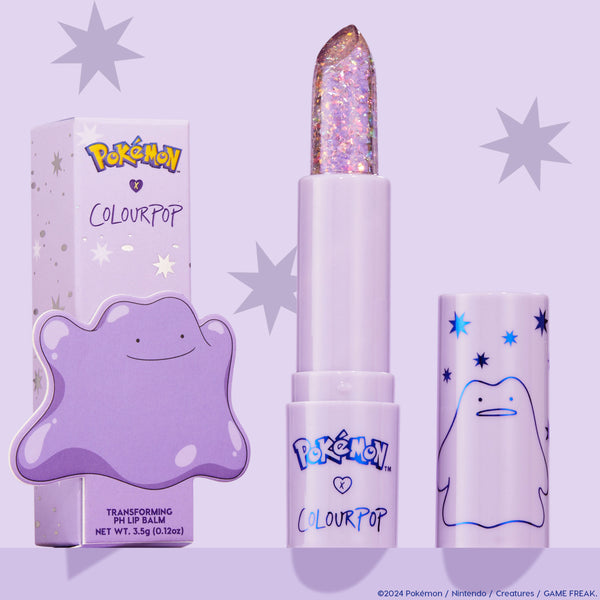 ColourPop pH Lip Balm Transform shown uncapped, revealing a clear glittery bullet, positioned between its lilac starry box and matching cap featuring Ditto from the Pokémon collab on a pastel purple background.