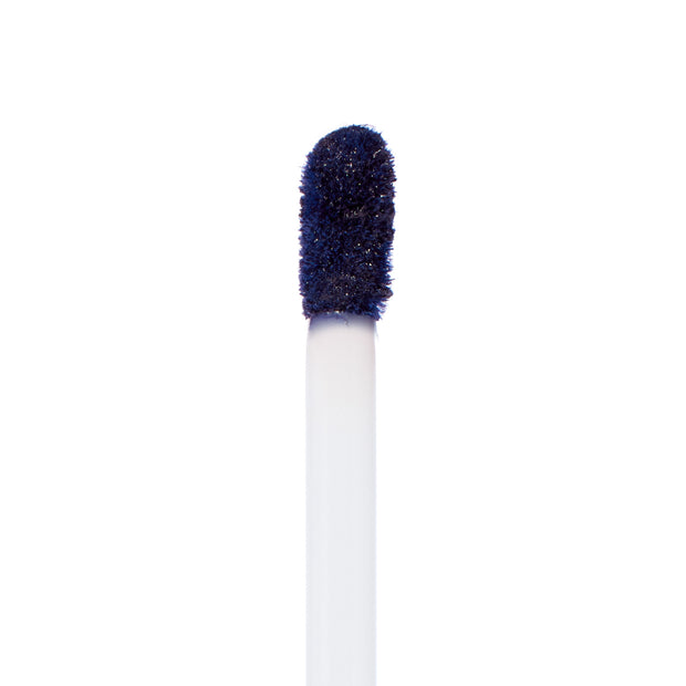 Doe-foot applicator coated in Panther, a deep midnight navy ColourPop Ultra Matte Lip, showcasing the velvety matte formula on a white wand against a clean white background.