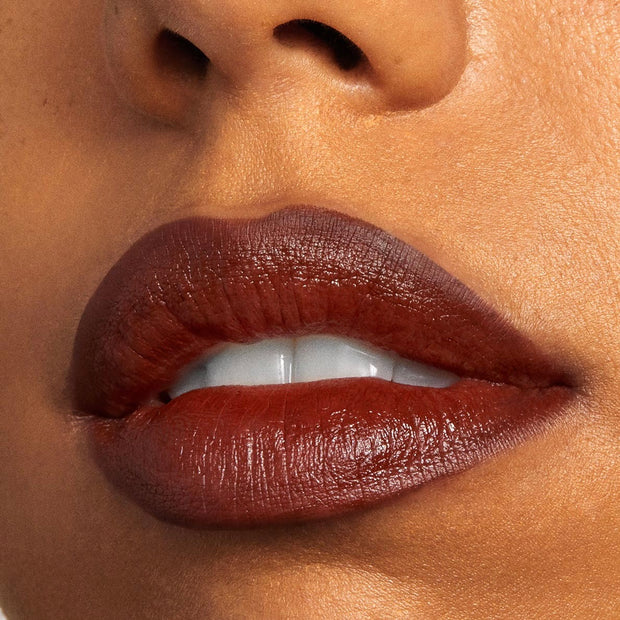 Full lips lined and filled with Pitch, a rich warm chocolate-brown ColourPop Lippie Pencil, delivering a smooth satin finish and crisp definition in a tight close-up beauty shot.