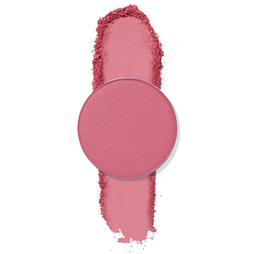 ColourPop Poodle pressed powder eyeshadow, a round single pan in matte rosy pink, sits atop a vertical swatch with soft crumbled edges, showcasing smooth, blendable pigment on a clean white background.