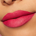 Lips wearing ColourPop Lippie Pencil in I Heart This, lined and filled in a bold fuchsia pink, showcasing a smooth, creamy matte finish in a close-up lip swatch.