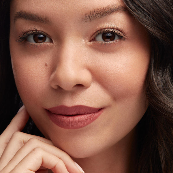 Lips lined and filled with Good N Plenty ColourPop Lippie Pencil, a rosy mauve matte, creating smooth, precise definition; close-up of a model’s face with soft neutral makeup and natural lighting.