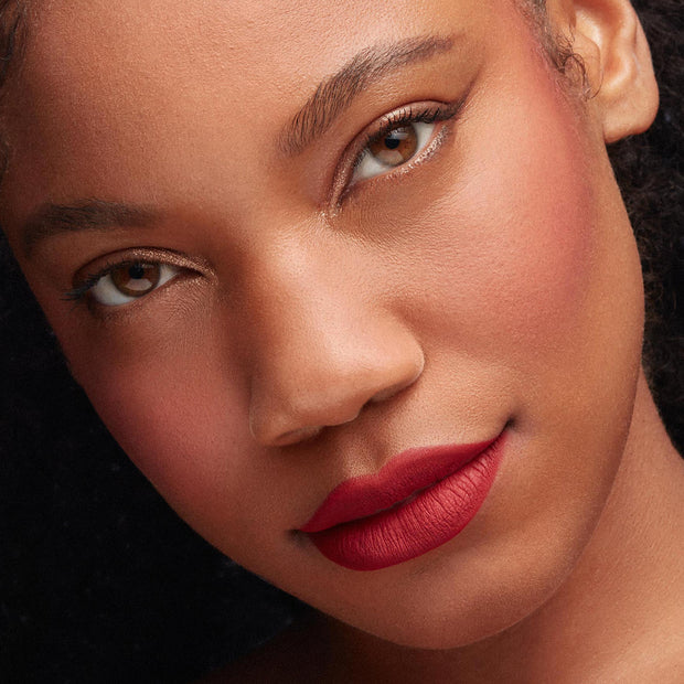 Bossy ColourPop Lippie Pencil lining and filling lips in a deep blue‑red matte, creating crisp, velvety edges; close-up beauty portrait with soft shimmer eyeshadow and natural complexion, highlighting precise lip liner results.