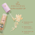 Colourpop Disney Princess Ultra Glossy Lip tube with wand swiping shimmery gold gloss in a floral swirl on a green background, highlighting hyaluronic acid hydration, Kakadu plum vitamin C, and sweet cherry oil softening benefits.