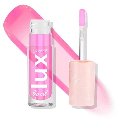 Raspberry Mojito ColourPop Lux Lip Oil shown open - clear tube with white Lux logo and a doe‑foot applicator coated in glossy hot‑pink tint - beside a peach cap with white starbursts and a bold pink swatch on a white background.