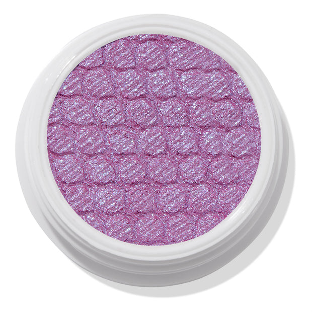 ColourPop Ripple Super Shock Shadow, a shimmering lavender eyeshadow with blue-violet sparkle, fills a textured quilted pan in a round white pot, shown top-down on a clean white background.