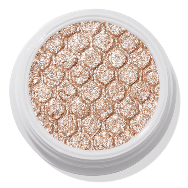 ColourPop Ritz Super Shock Shadow shimmering in a white round pot, its honeycomb-embossed, metallic champagne-beige glitter cream-to-powder formula catching light in a close-up product shot on a clean background.