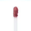 Doe-foot applicator swiping Rose Latte Ultra Blotted Lip, a rosy mauve-brown shade with a soft blurred finish, against a white background; ColourPop Ultra Blotted Lip macro highlighting plush bristles and creamy texture.