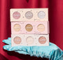 ColourPop Matcha and Mochi Super Shock Shadow trio, three pastel palettes of shimmery eyeshadows stacked on a teal satin glove against a red curtain backdrop, showcasing glittery metallic shades for vibrant eye looks.