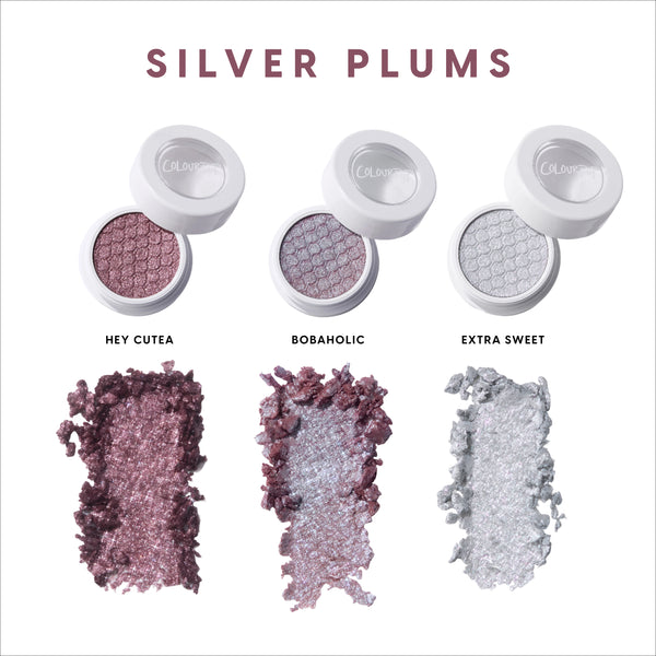 ColourPop Milk Tea and Boba Super Shock Shadow trio called Silver Plums showing three open pots and crushed swatches of shimmery plum, lavender, and icy silver shades labeled Hey Cutea, Bobaholic, and Extra Sweet on a white background.