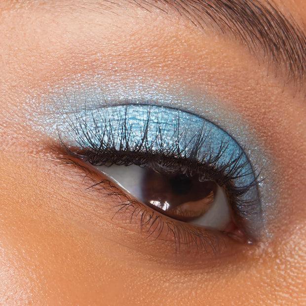 Hydro Pump Super Shock Shadow swept across a closed eyelid, showing metallic sky-blue shimmer and smooth payoff along the lash line and crease; ColourPop Super Shock Shadow eye look close-up for product detail.