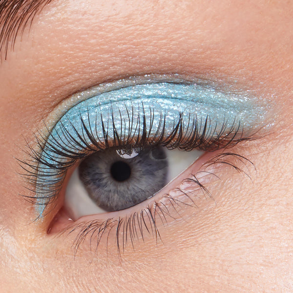 Shimmery aqua-blue eyeshadow sweeps across the eyelid, showcasing ColourPop Super Shock Shadow in Hydro Pump with a metallic, glittery finish and natural lashes, captured close-up to highlight the cool-toned, icy blue payoff.