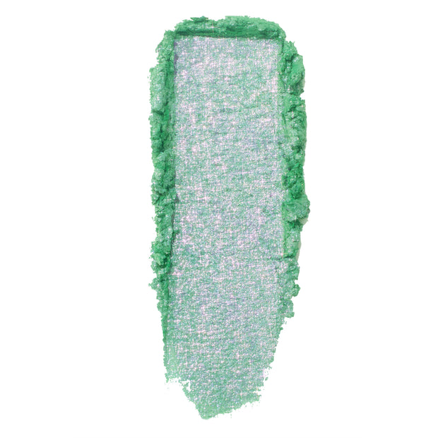 Mint-green swatch with iridescent pink-lilac shimmer glides downward with soft, crumbly edges, showcasing the creamy metallic payoff of Solar Beam, a ColourPop Super Shock Shadow, on a clean white background.