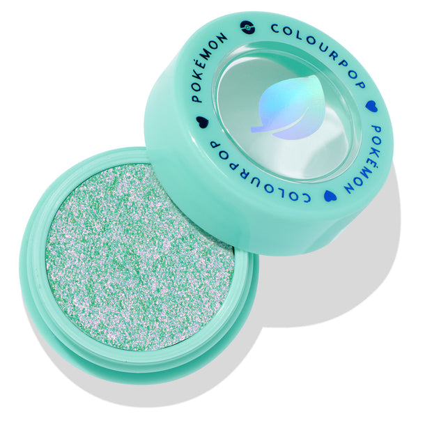 Solar Beam ColourPop Super Shock Shadow sitting open to reveal a sparkling mint-green and pink duochrome eyeshadow, in a mint compact with clear lid and blue COLOURPOP POKÉMON lettering and leaf icon.