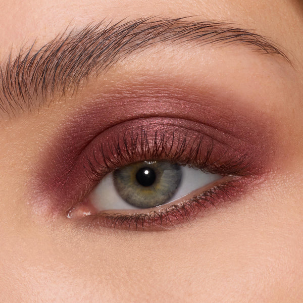 Deep burgundy metallic shadow sweeps across the eyelid and lower lash line, showcasing The Volturi Super Shock Shadow’s smooth, creamy payoff; the ColourPop Super Shock Shadow blends seamlessly with soft shimmer in a close-up eye.