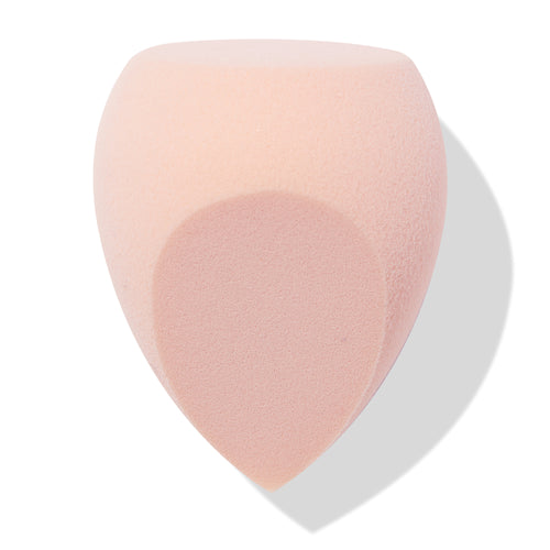 Blush-pink Sculpting Sponge blending foundation and contour with a flat top, rounded sides, and a pointed precision tip, shown angled on a white backdrop with soft shadow; ColourPop Makeup Tools & Accessories for seamless application.