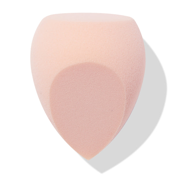 Blush-pink Sculpting Sponge blending foundation and contour with a flat top, rounded sides, and a pointed precision tip, shown angled on a white backdrop with soft shadow; ColourPop Makeup Tools & Accessories for seamless application.